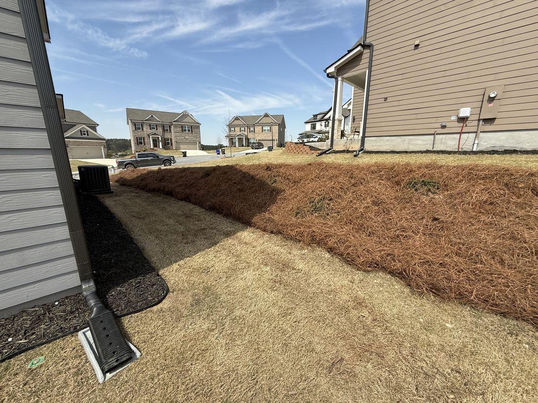 Home corner and downspout serviced by Kaus Cuts