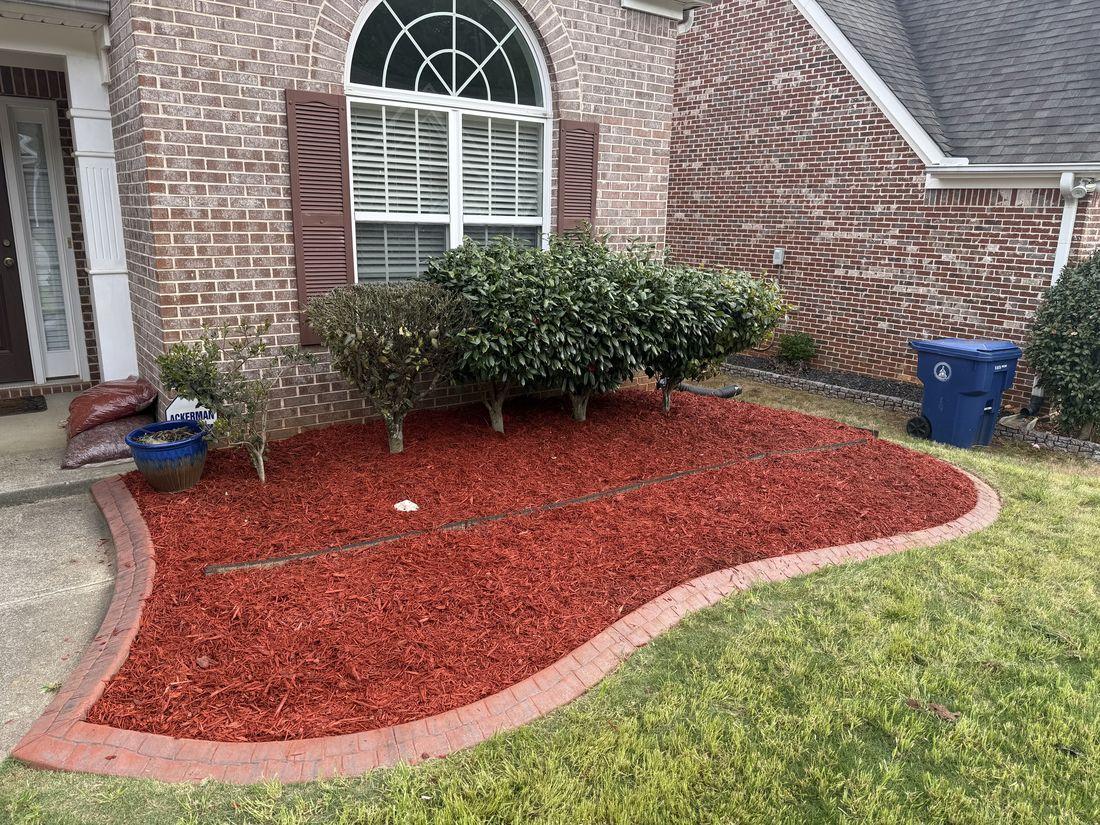 Fresh red mulch bed and clean edging by Kaus Cuts